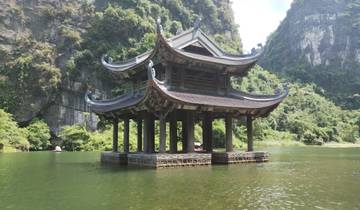 A floating pavilion with a mountainous backdrop.