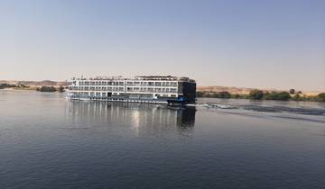 A cruise ship sailing on a river.