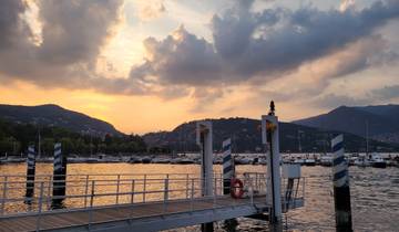 Sunset view over a marina with mountains in the background.
