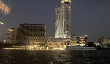 City skyline at night with illuminated buildings.