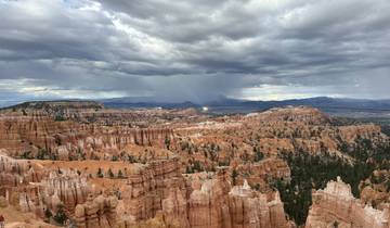 Expansive canyon with storm clouds in the distance