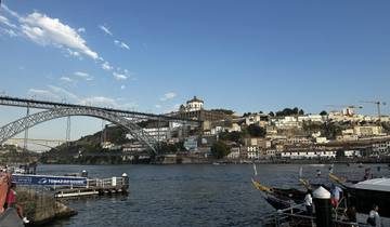 Riverside view with a bridge, historic buildings, and boats.