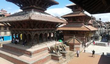 Temple structures with tourists and statues in Kathmandu.