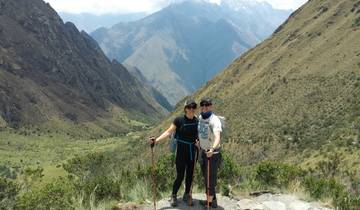 Two people hiking with stunning mountain views in the background.
