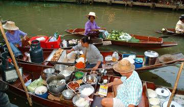 Floating market with people interacting and selling goods on boats.