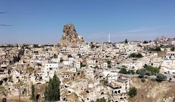 Wide view of a town with a distinct rocky formation.