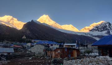 Village in the mountains with sunlit peaks.