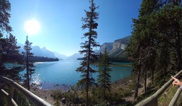 Scenic view of a lake surrounded by trees and mountains