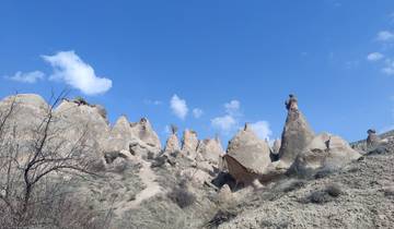 Unique rock formations under a clear blue sky.