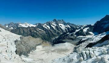 Snow-covered mountains with a glacier in the foreground.