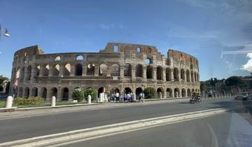 The Colosseum in Rome, viewed from a moving vehicle.