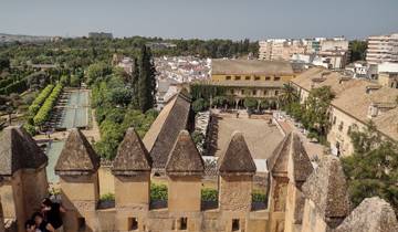 Scenic view of a city with historical architecture and gardens.