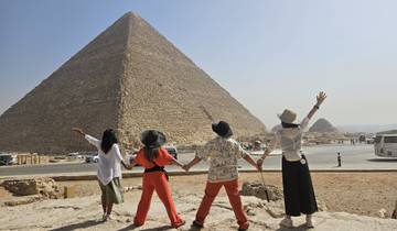 A group of people facing the Great Pyramid of Giza.