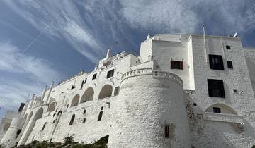 White buildings with arches and a clear sky.