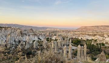 Cappadocia's iconic rock formations under a sunset sky.