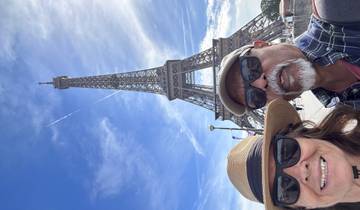 Tourists posing near the Eiffel Tower.