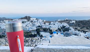 Town with white buildings and a blue dome in the landscape.