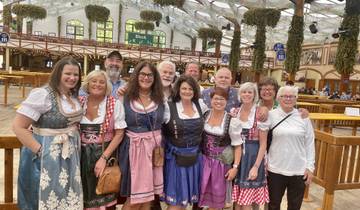 Group in traditional Bavarian clothing taken indoors.
