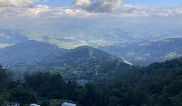 Mountainous landscape with winding roads and valleys.