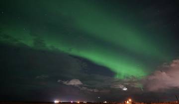 Northern lights in the night sky with stars.