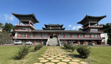 Traditional Korean building with twin towers under a clear sky.