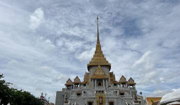 Large golden temple under a cloudy sky.