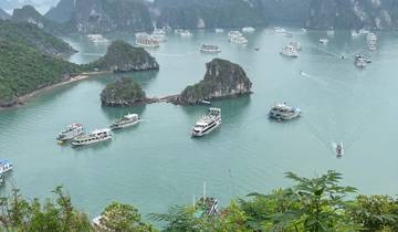 Aerial view of Halong Bay with boats and karst formations.