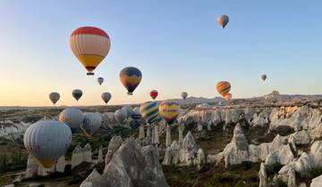 Hot air balloons soaring above a rocky landscape