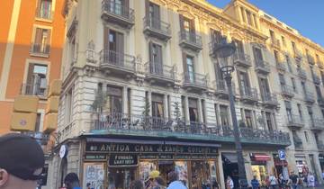 Historic building with balconies and storefronts.