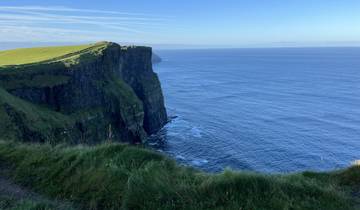 Cliffs overlooking the ocean with blue skies.