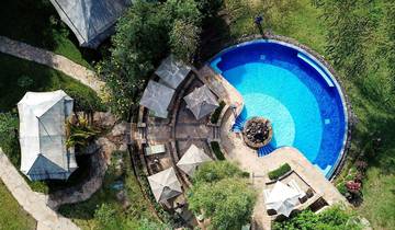 Aerial view of a pool and surrounding area at a resort.