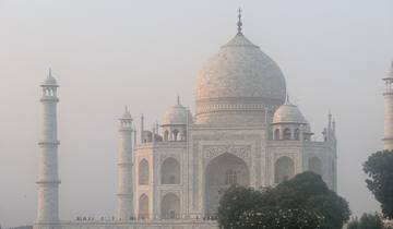 Iconic white marble mausoleum under a hazy sky.