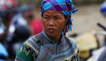 Portrait of a woman with a colorful headdress.