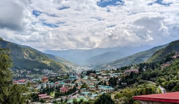 Panoramic view of a Bhutanese town with mountains.
