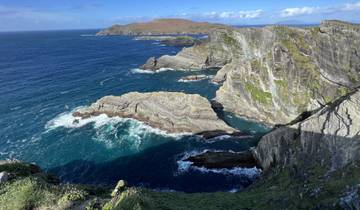Rocky coastal cliffs with choppy ocean waves.