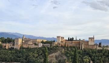 Alhambra palace complex with mountains in the background.