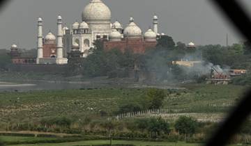 A view of the Taj Mahal framed by a window.
