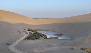 Crescent Lake oasis surrounded by sand dunes.