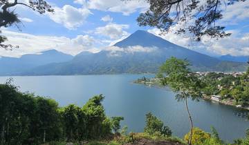View of a volcanic lake surrounded by greenery.