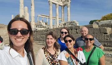 Group posing in front of ancient ruins with columns.