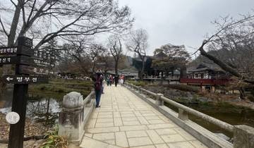 People walking on a bridge in a historic area.