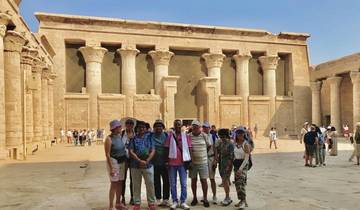 Group of people posing in front of ancient Egyptian temple.