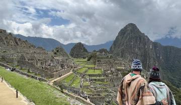 Couple looking at the ancient ruins of Machu Picchu.