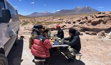 Group of people having a picnic in a mountainous area.