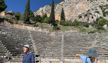 Ancient theatre with tourists exploring.