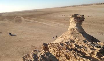 Desert landscape with rocky formation.