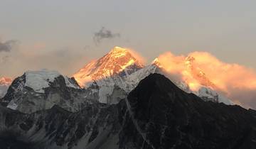 Snow-capped mountain peaks with a golden sunset glow.