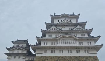 Himeji Castle against a cloudy sky.