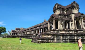 An ancient temple with detailed carvings, people exploring the site.