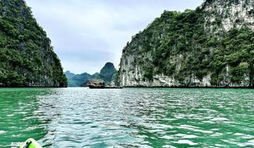 Dramatic cliffs surrounding a bay with boats.